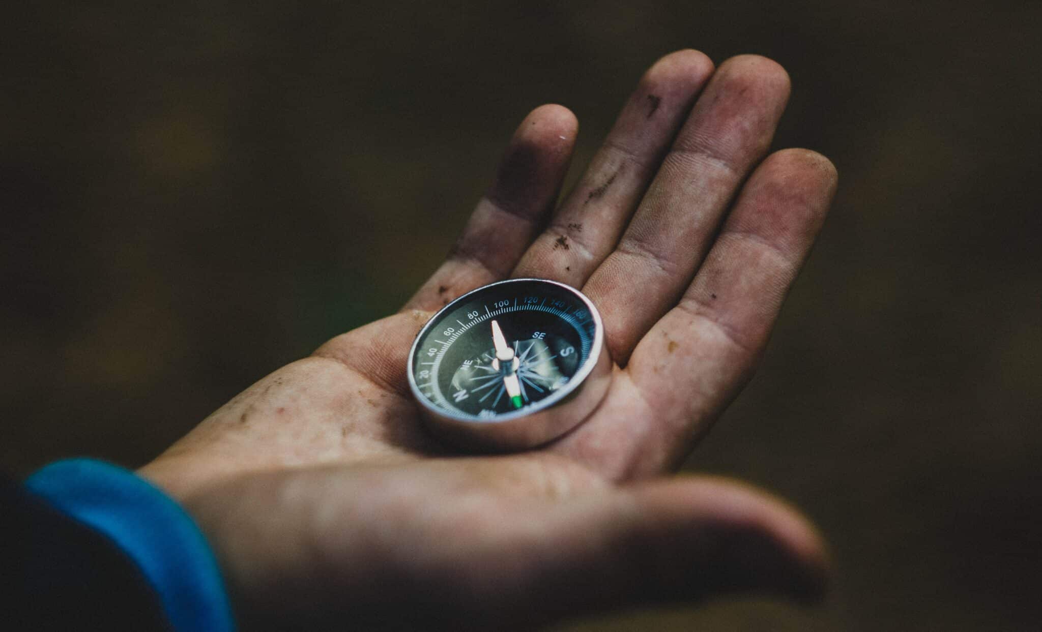 Looking at a compass to determine your next direction.